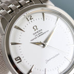 Close-up of Omega Seamaster watch face with gold hands and silver metal bezel