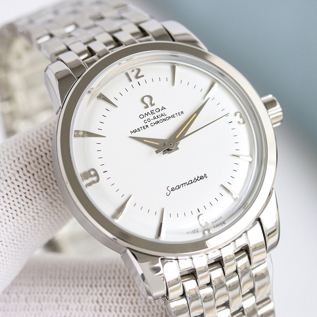 Omega Seamaster watch with silver bracelet and white dial, gold hands and markers