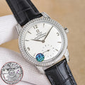 Silver analog wristwatch with diamond bezel, white dial, black leather strap