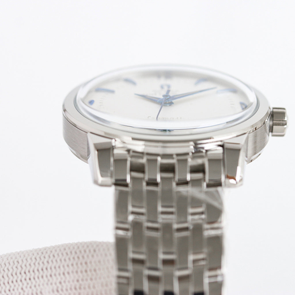 Seamaster wristwatch front view with silver bracelet and white dial, blue hands