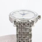 Seamaster wristwatch front view with silver bracelet and white dial, blue hands