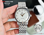 Silver metal wristwatch with white dial, gold hands, and metal link bracelet