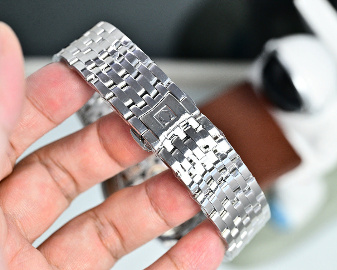 Silver metal wristwatch bracelet and case, polished links held in a hand