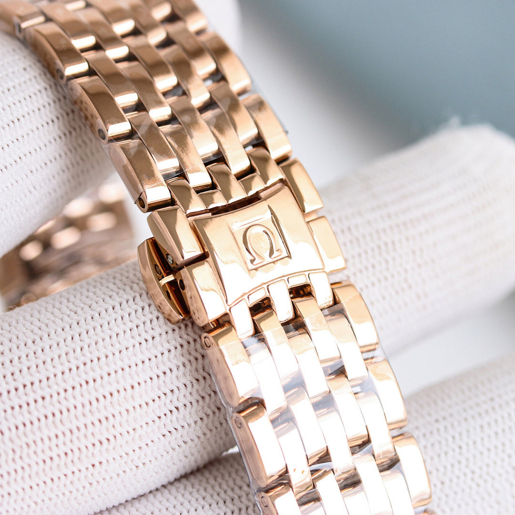 Omega Seamaster watch with rose-gold bracelet close-up and clasp detail