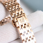 Omega Seamaster watch with rose-gold bracelet close-up and clasp detail