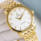 Omega Seamaster watch close-up with gold case, white dial, and gold bracelet