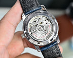 Omega Seamaster stainless caseback on blue leather strap, exposed mechanical dial