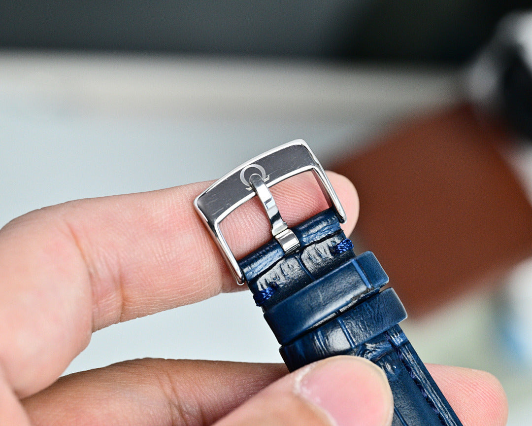 Omega Seamaster leather strap with blue tone, silver buckle clasp on hand