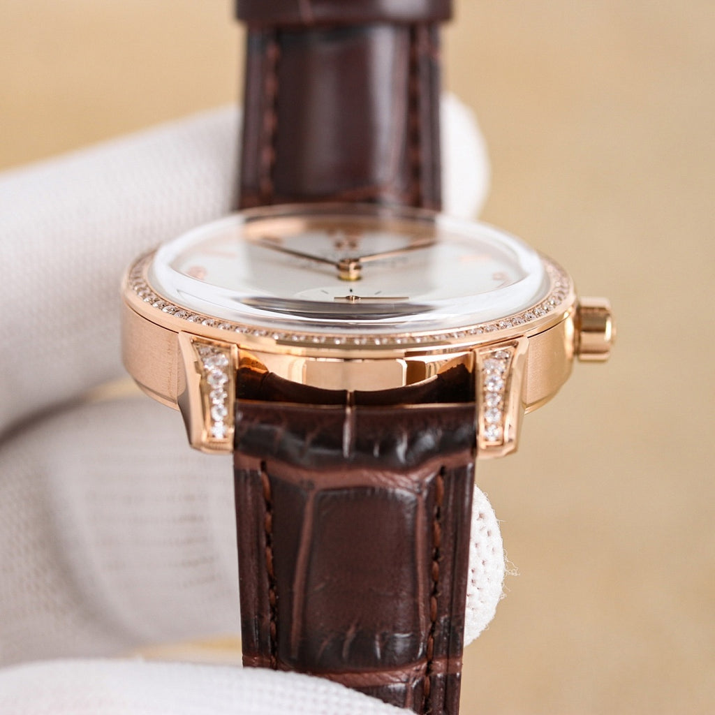 Rose-gold watch case with white dial, diamond bezel, brown leather strap