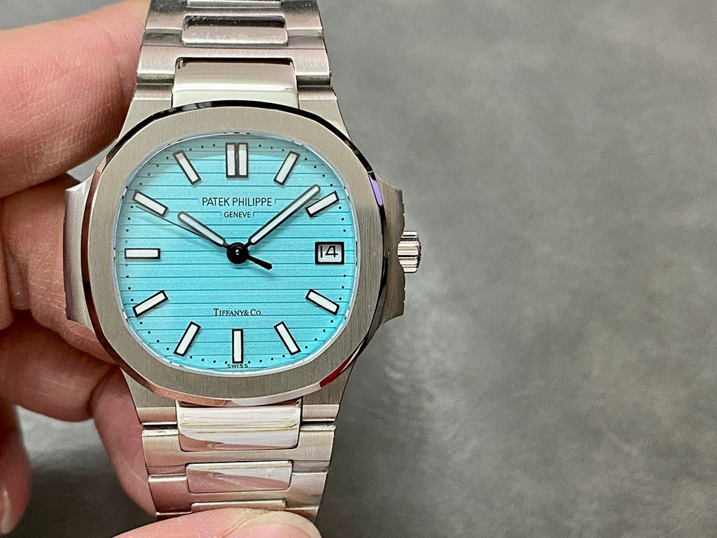 Patek Philippe wristwatch, light blue dial with black hands and baton markers; date window at 3