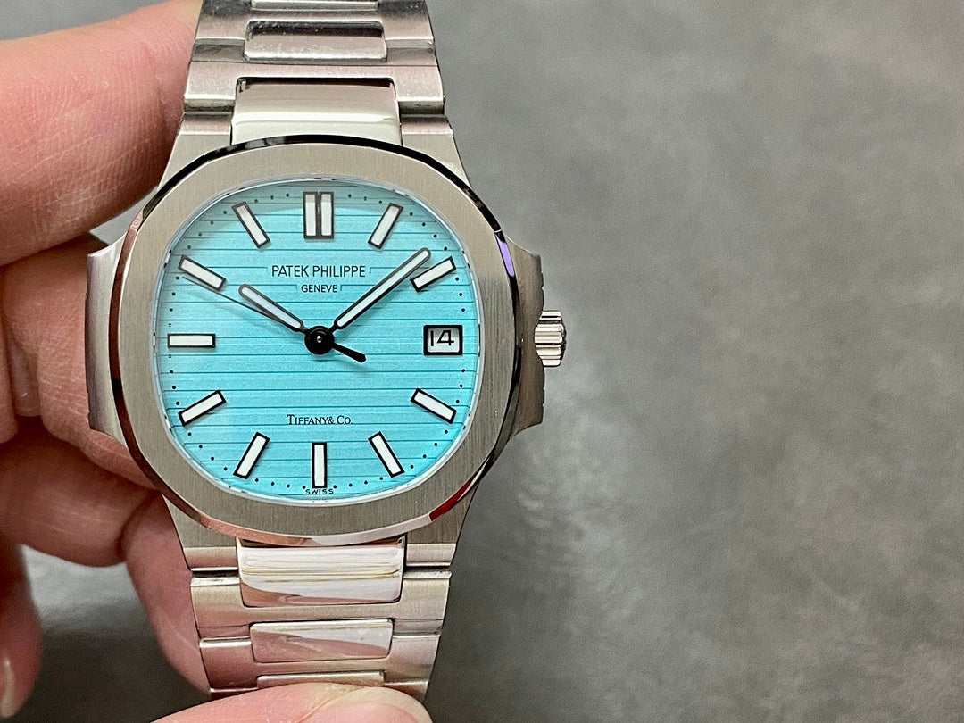 Patek Philippe wristwatch, light blue dial with black hands and baton markers; date window at 3