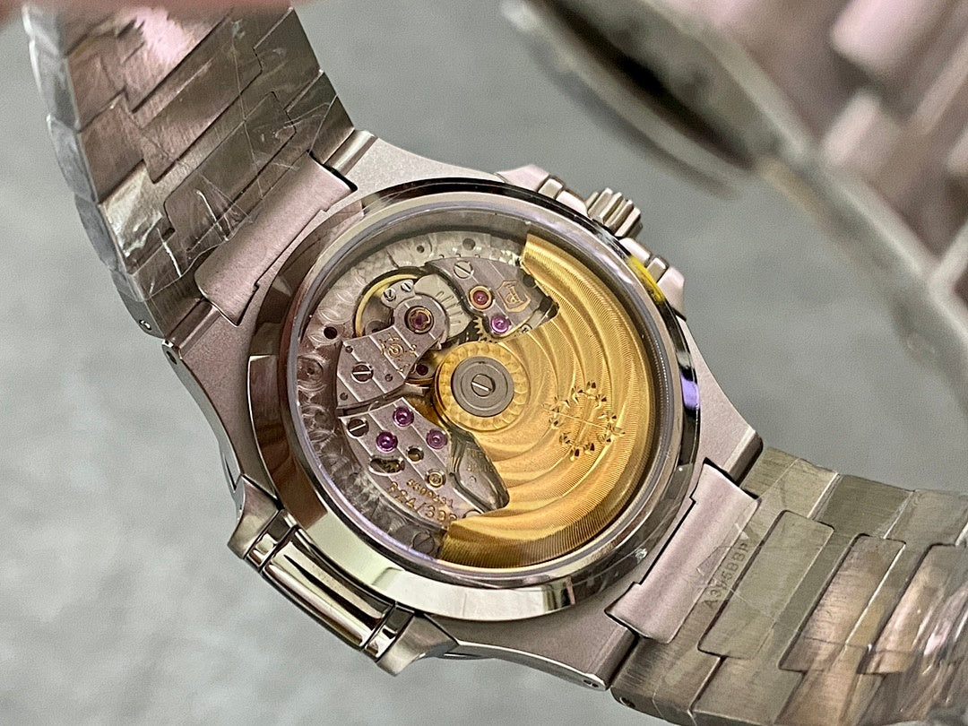 Patek Philippe wristwatch open caseback showing mechanical movement with gold-toned center
