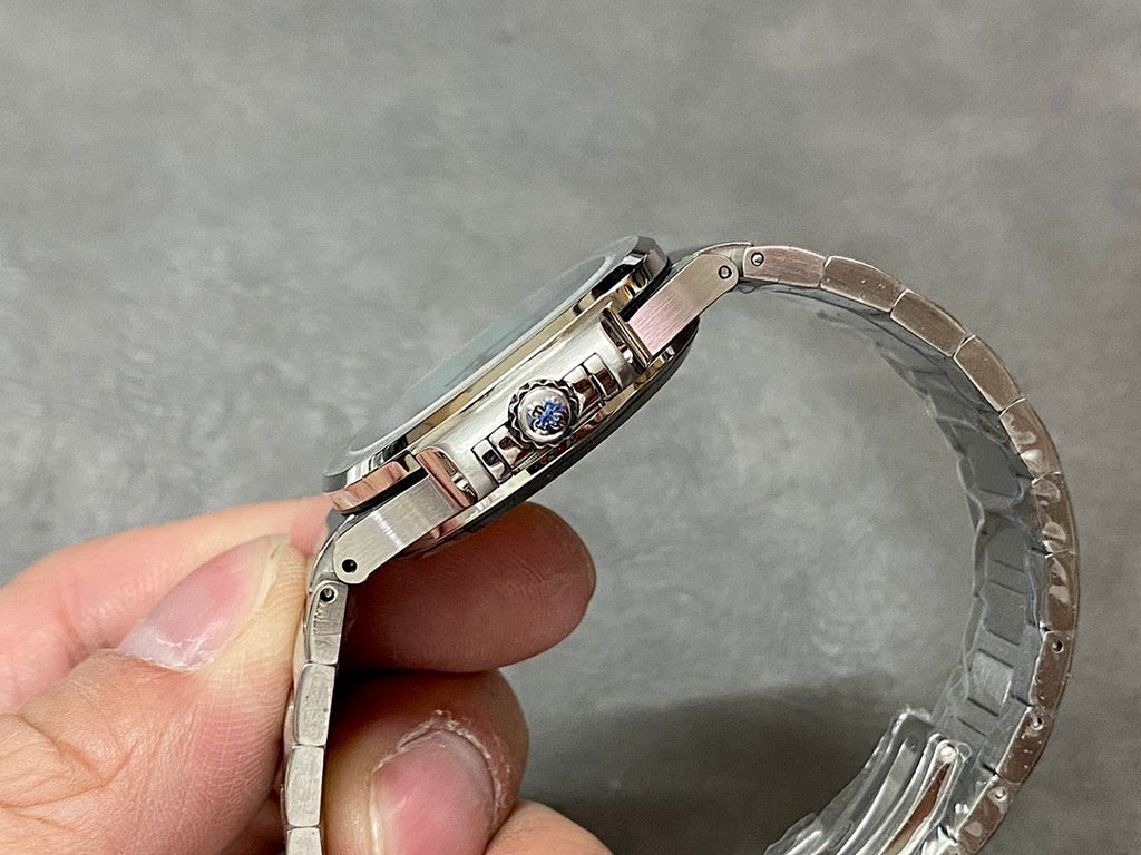 Patek Philippe wristwatch clasp and bracelet links in silver-tone metal