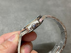 Patek Philippe wristwatch clasp and bracelet links in silver-tone metal