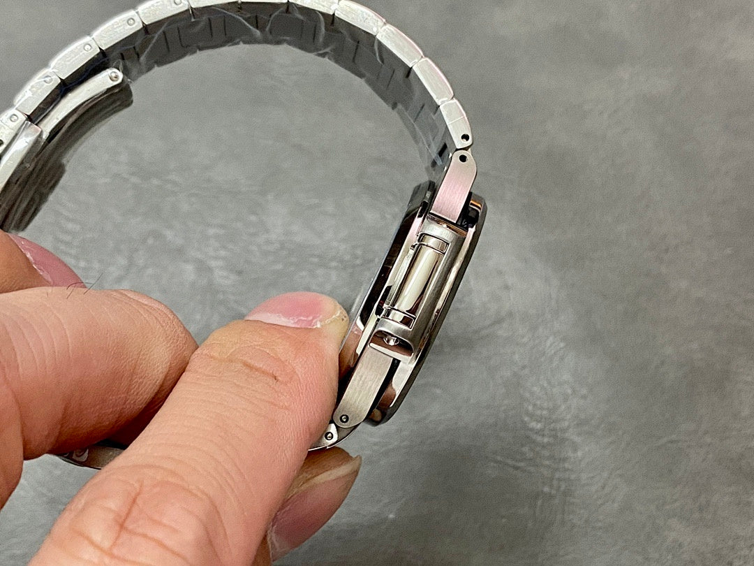 Patek Philippe wristwatch side view with silver-tone bracelet and crown area