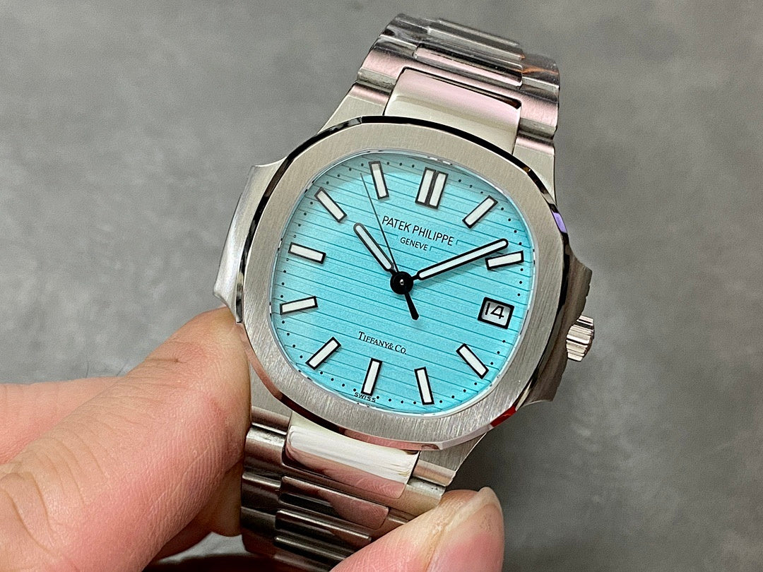 Patek Philippe wristwatch with light blue dial, silver-tone metal bracelet, baton hour markers
