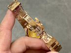 Patek Philippe gold-tone bracelet watch case side view, crown and clasp detail
