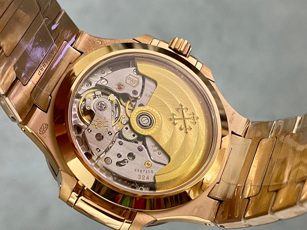 Patek Philippe watch case back with gold-toned movement visible