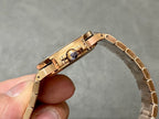 Patek Philippe watch clasp and caseback, gold-tone bracelet held upright