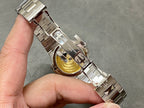 Wristwatch bracelet clasp underside with metal links and engraved logo