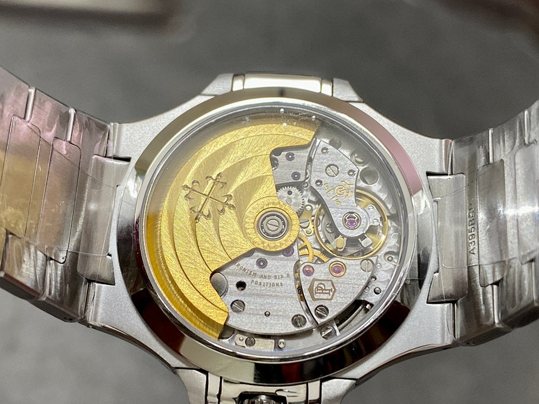Wristwatch open caseback showing gold-toned rotor and visible mechanical components