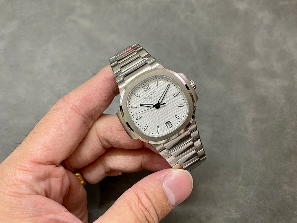 Wristwatch with silver dial, black hands, baton markers, steel bracelet