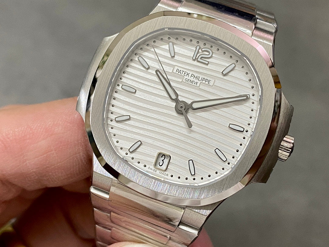 Patek Philippe wristwatch with silver dial, baton markers, date window at 3, steel bracelet