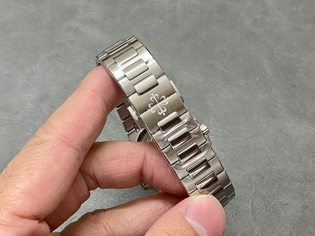 Patek Philippe wristwatch bracelet links in silver metal.