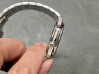 Patek Philippe wristwatch side profile with silver bracelet links.