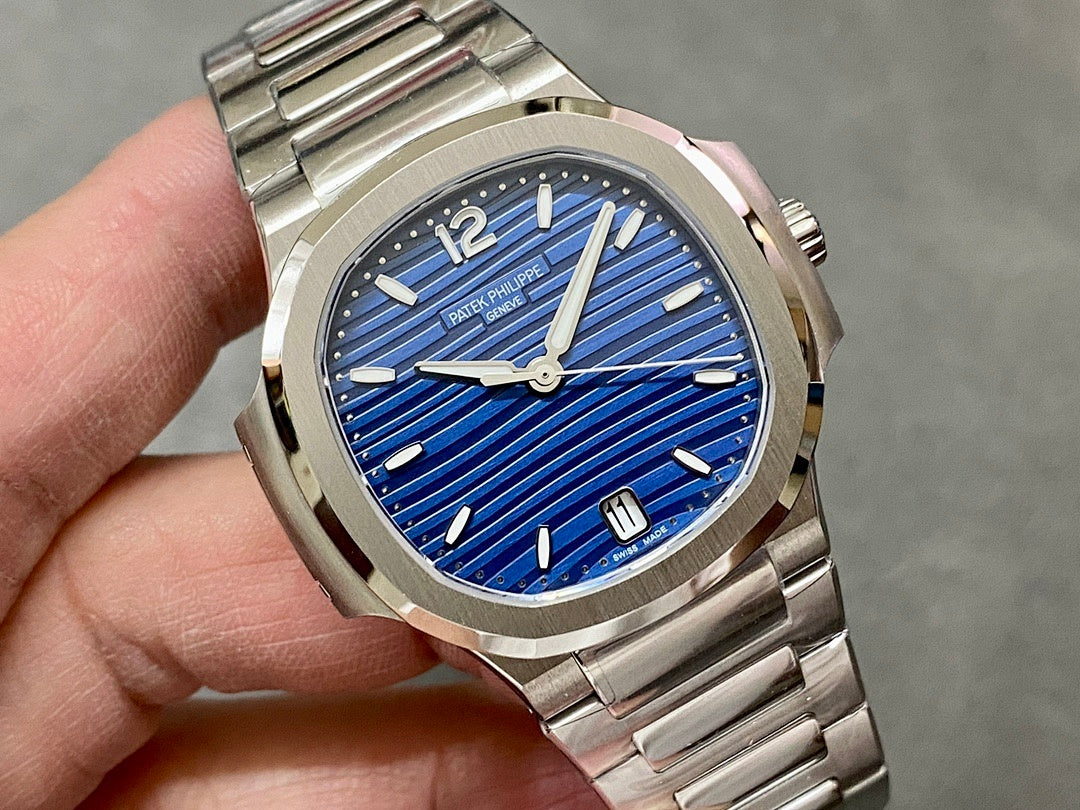 Patek Philippe wristwatch close-up with blue dial and silver hands.