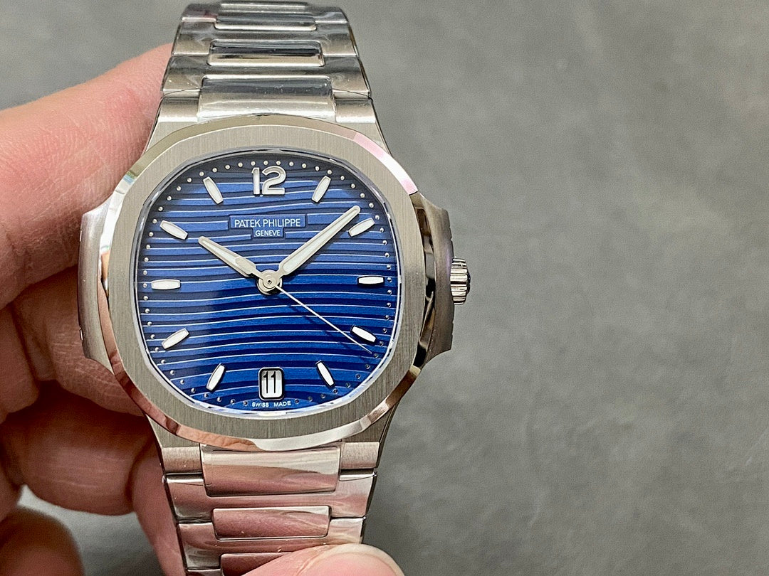 Patek Philippe wristwatch with blue dial and stainless steel bracelet.