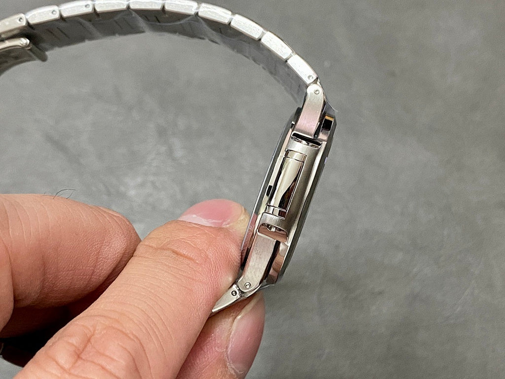 Patek Philippe wristwatch bracelet held in hand, stainless links with polished edges
