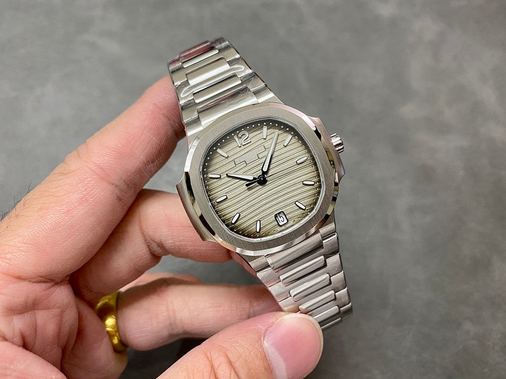 Patek Philippe wristwatch angled view: silver dial, baton hour markers, stainless bracelet
