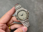 Patek Philippe wristwatch angled view: silver dial, baton hour markers, stainless bracelet