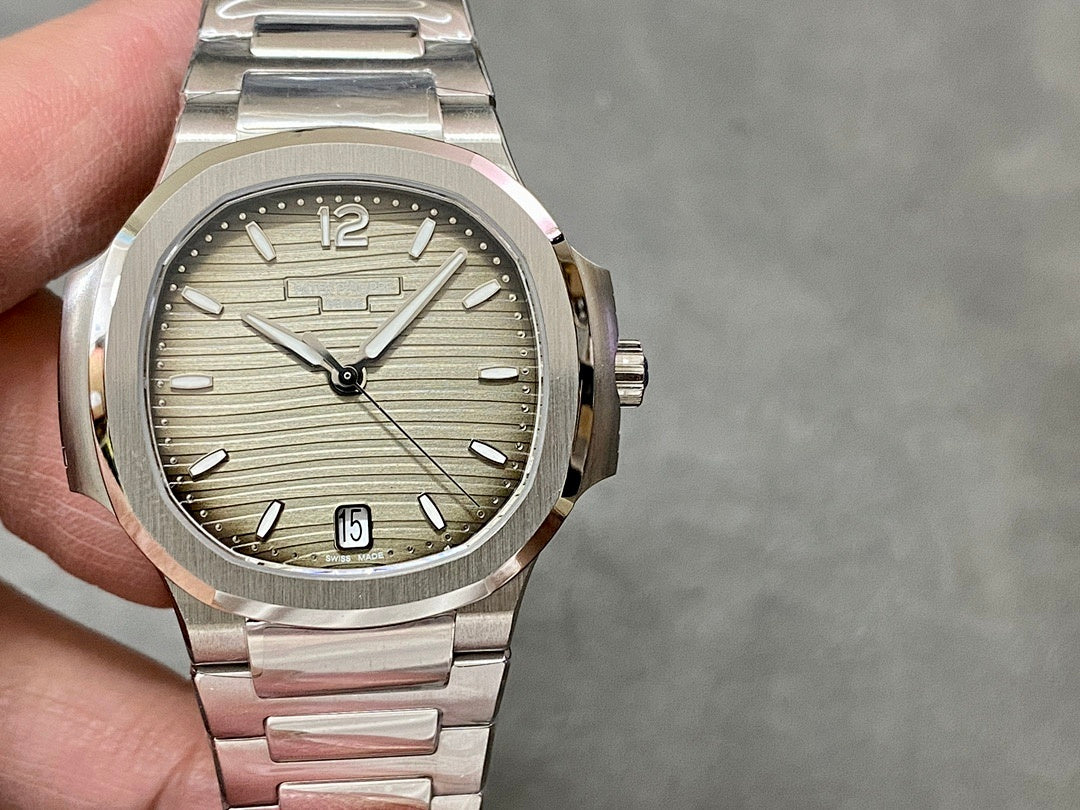 Patek Philippe wristwatch front view with silver dial, baton markers, date window, stainless bracelet