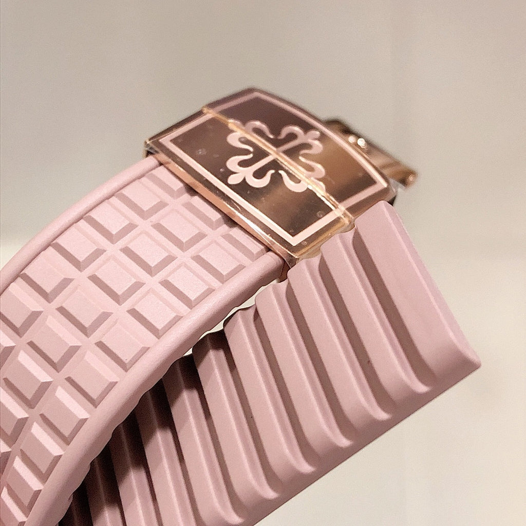 Patek Philippe watch strap close-up with light pink pattern and metal clasp detail