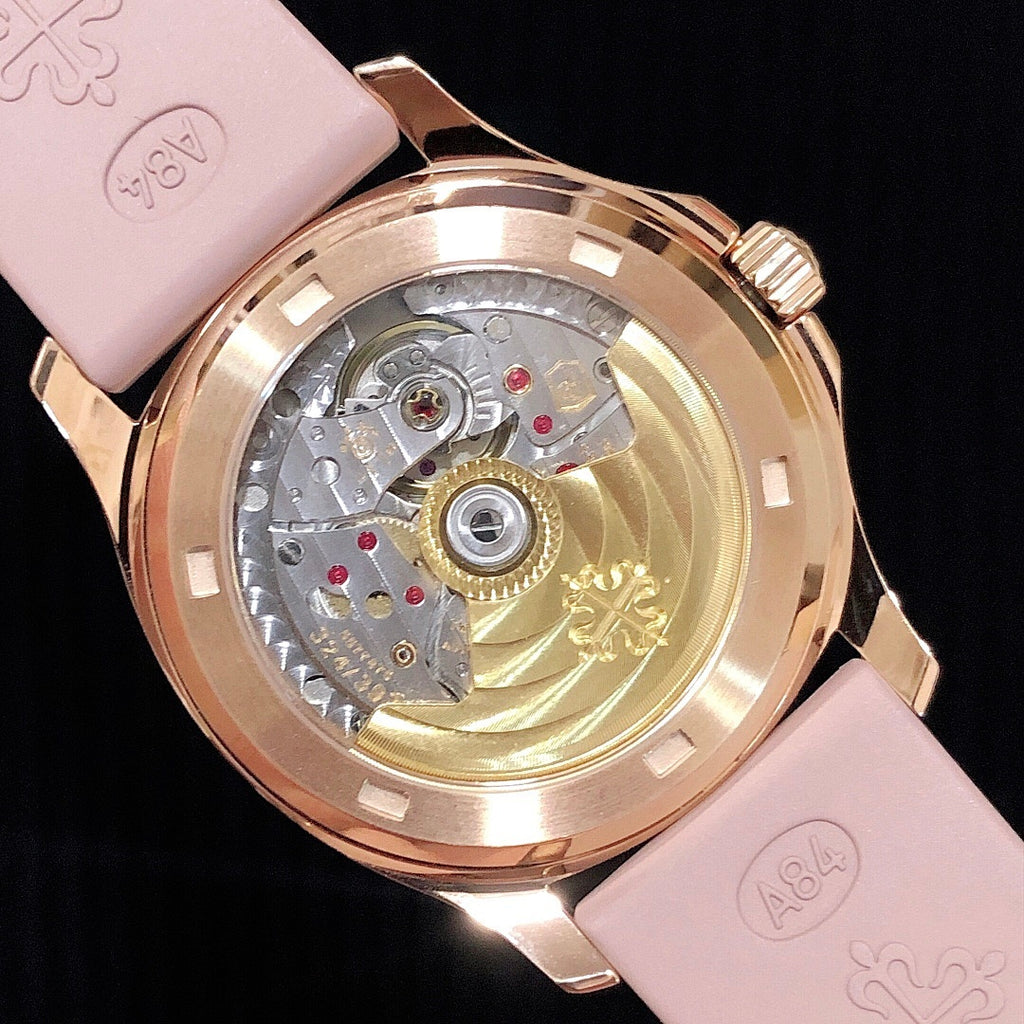 Patek Philippe watch caseback with visible movement and pink strap