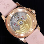 Patek Philippe watch caseback with visible movement and pink strap