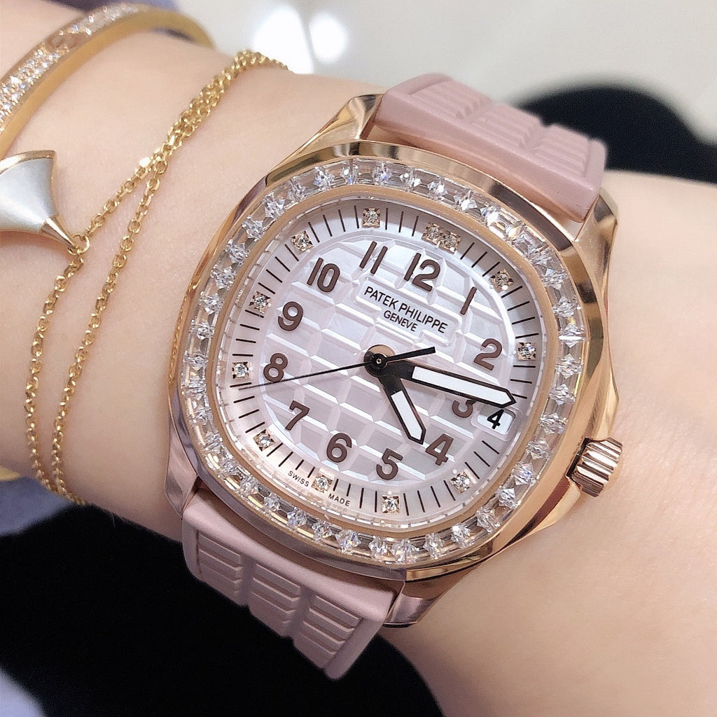 Patek Philippe watch with pink silicone strap, rose-gold case, diamond bezel, white dial