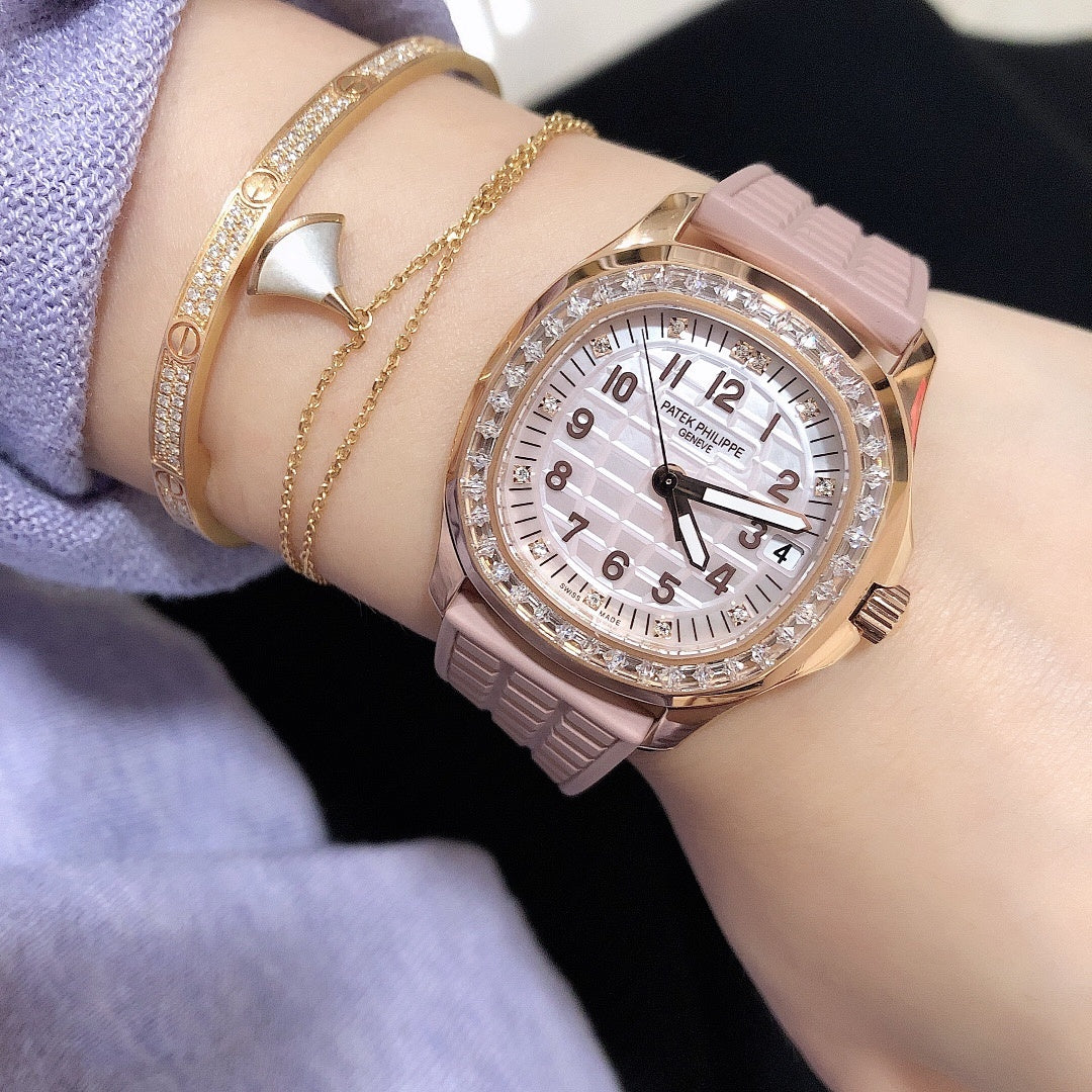 Patek Philippe watch with pink strap, rose-gold case, and diamond bezel over a white dial