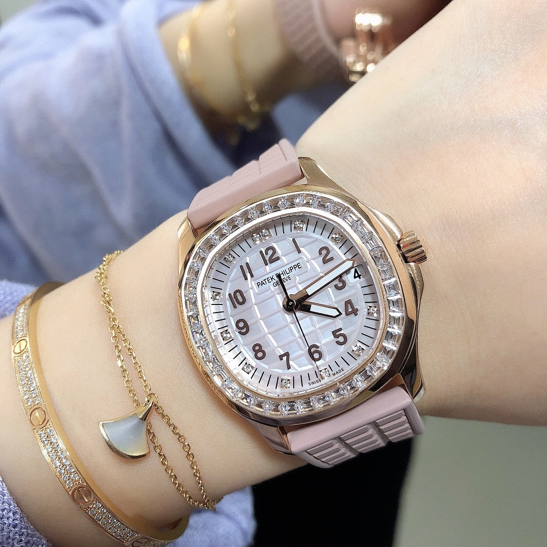 Patek Philippe watch on wrist with pink strap, rose-gold case, and diamond bezel