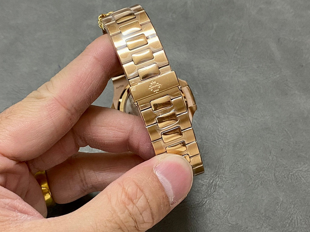 Gold-tone metal bracelet with linked links and clasp, shown from side/back