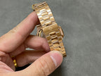 Gold-tone metal bracelet with linked links and clasp, shown from side/back