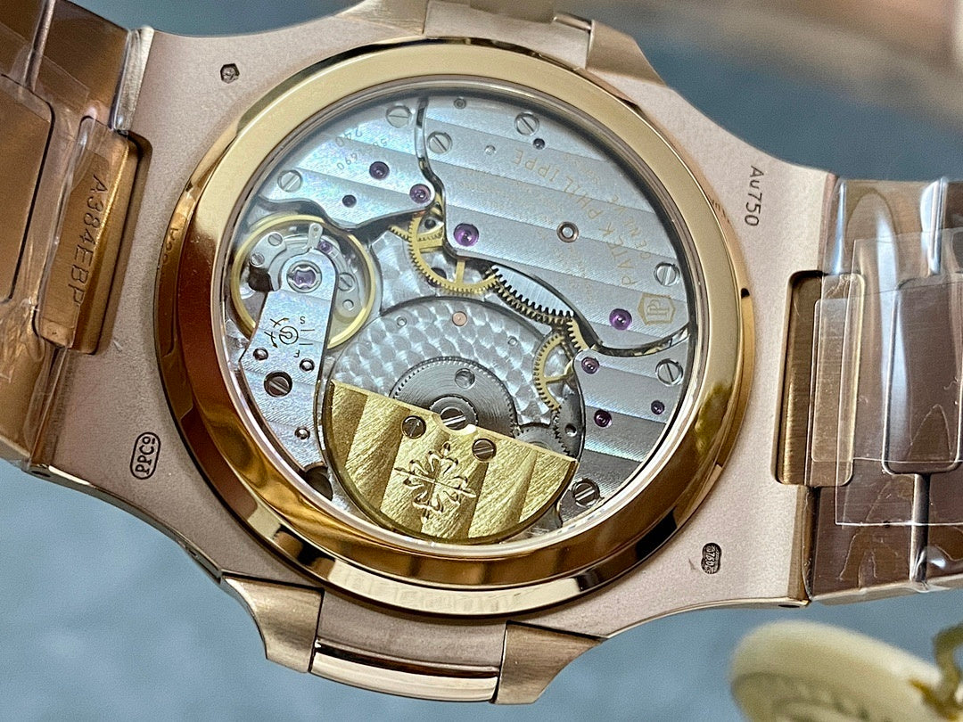 Open watch caseback showing gold balance bridge and mechanical gears, gold-tone