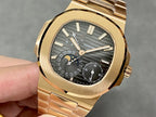 Gold-tone Patek Philippe wristwatch with black dial and gold bezel, held in hand