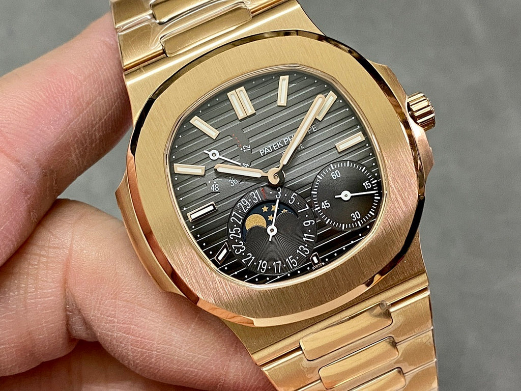 Gold-tone wristwatch close-up of black dial, gold hands and subdials