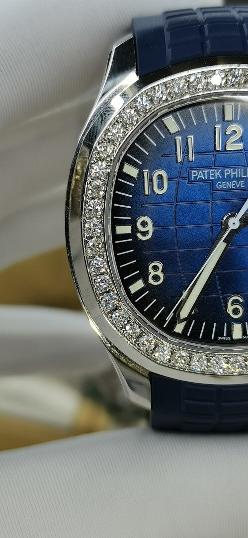 Patek Philippe watch close-up of blue dial with markers, diamond-set bezel.