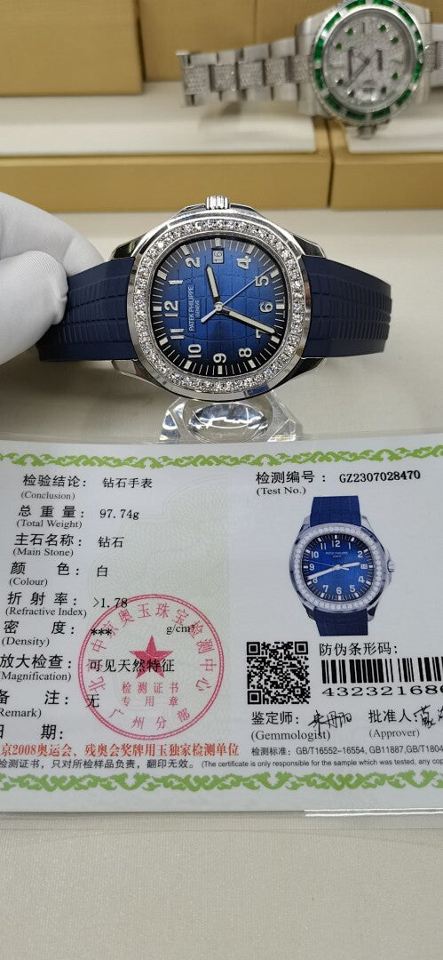 Patek Philippe watch with blue dial and diamond bezel on paperwork card, blue strap.