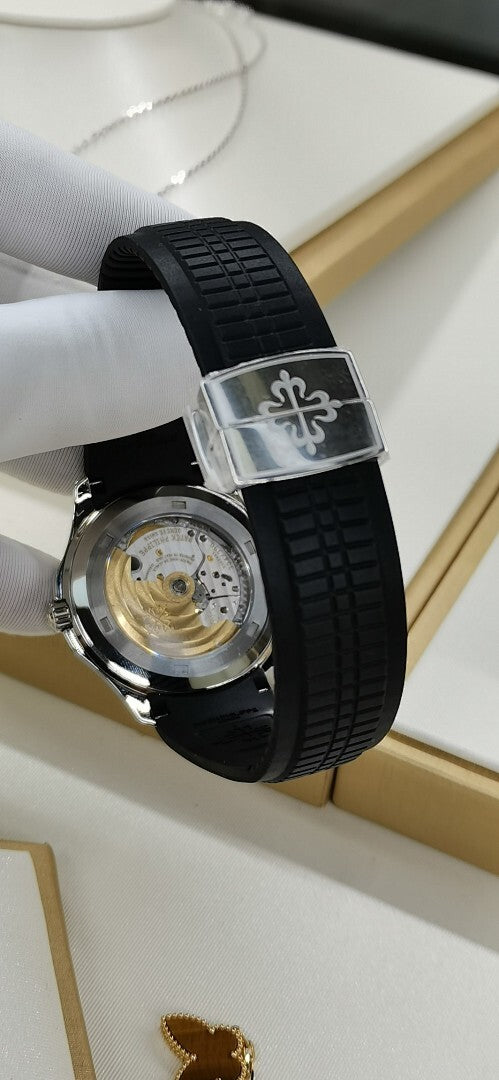 Patek Philippe wristwatch with black rubber strap and decorative clasp