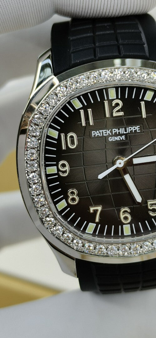 Patek Philippe watch close-up on black dial with diamond bezel and black rubber strap